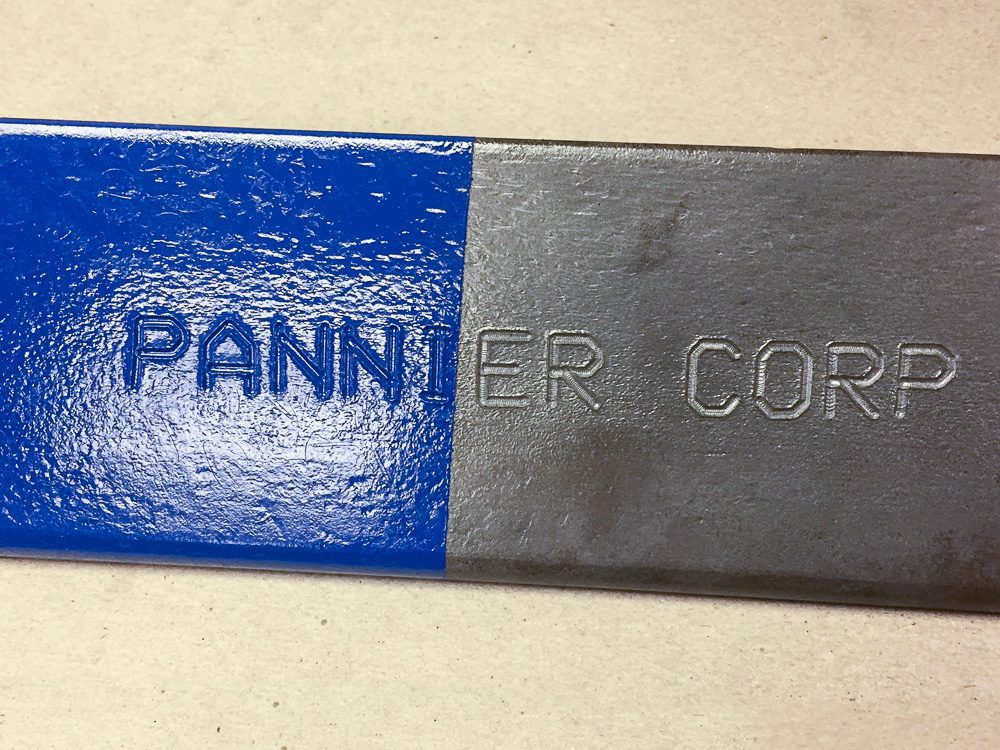 deep marking on a steel part with paint on top to show legibility