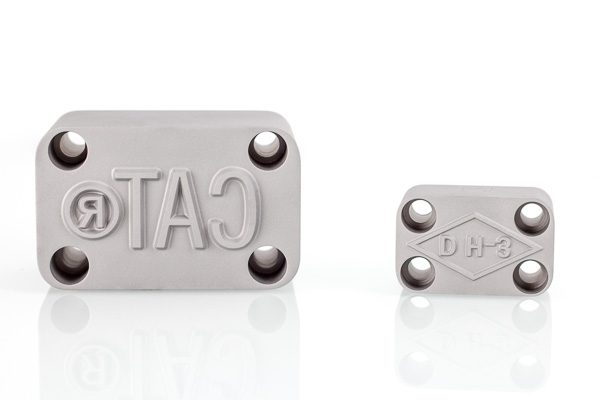 metal logo stamps with mounting holes for attaching to metal stamping presses