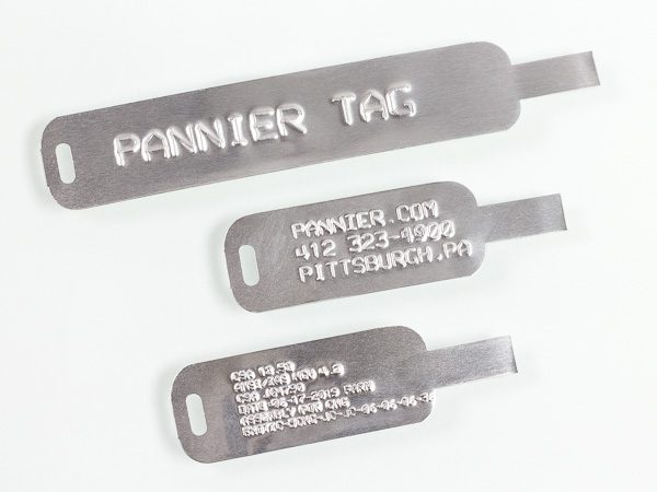 different sizes of self-attaching tongue and slot aluminum tags embossed with information