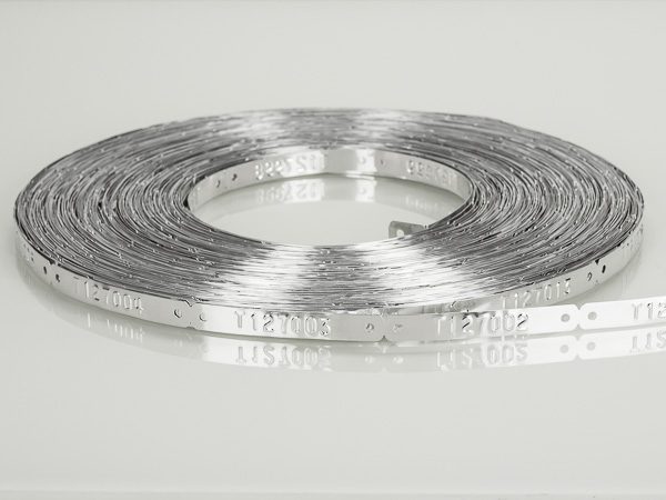 coil of steel tags with holes pre-embossed with serial numbers