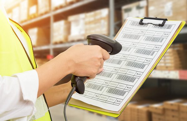 worker scanning bar codes on job paperwork